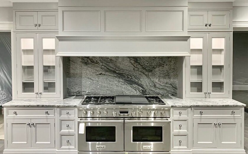 Kinawa White granite worktops with kitchen centrepiece splashback pattern. Landford Stone, Wiltshire. Designed by Hummingbird Design.