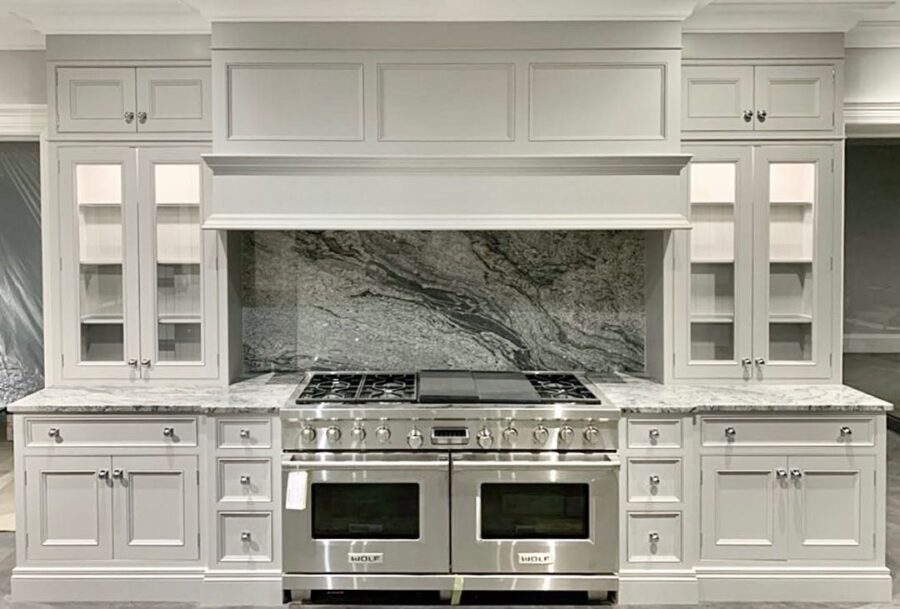 Kinawa White granite worktops with kitchen centrepiece splashback pattern. Landford Stone, Wiltshire. Designed by Hummingbird Design.