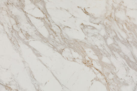 White marble surface with light brown and beige natural veining patterns.