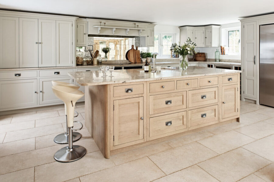 kitchen island with beige limestone worktops