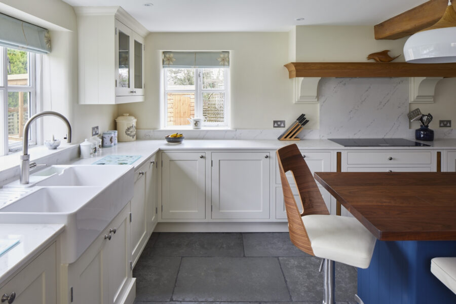 white kitchen cabinets with marble-effect quartz worktops, supplied by Landford Stone, Wiltshire