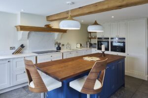 Classic white quartz worktops complete a shaker-style Milford Cottage kitchen