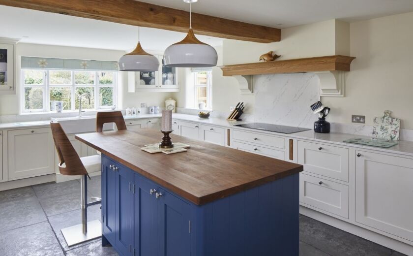 white and blue kitchen cabinets with marble-effect quartz worktops, supplied by Landford Stone, Wiltshire