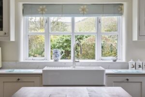 Classic white quartz worktops complete a shaker-style Milford Cottage kitchen