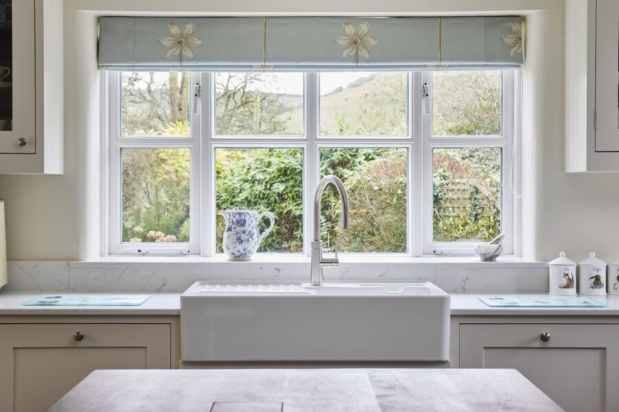 white kitchen cabinets with marble-effect quartz worktops, supplied by Landford Stone, Wiltshire