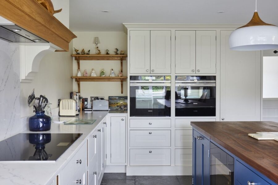 white kitchen cabinets with marble-effect quartz worktops, supplied by Landford Stone, Wiltshire